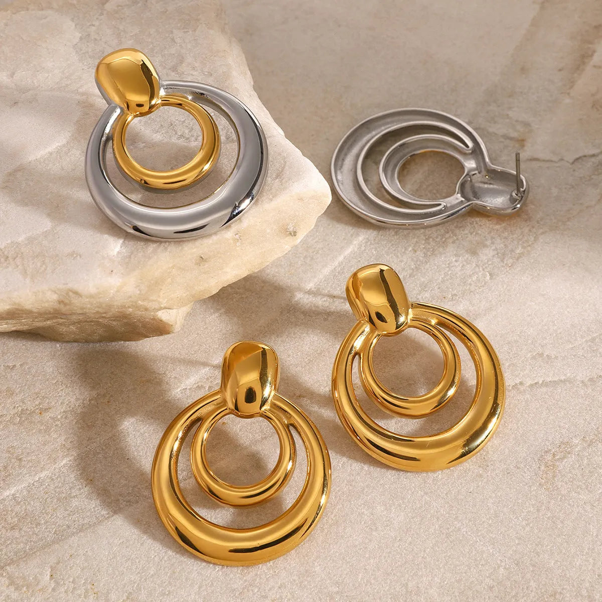 Golden round double layer hollow stud earrings with titanium steel construction and 18k gold plating