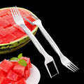 Silver stainless steel watermelon slicer and serving fork with a long handle on a kitchen surface