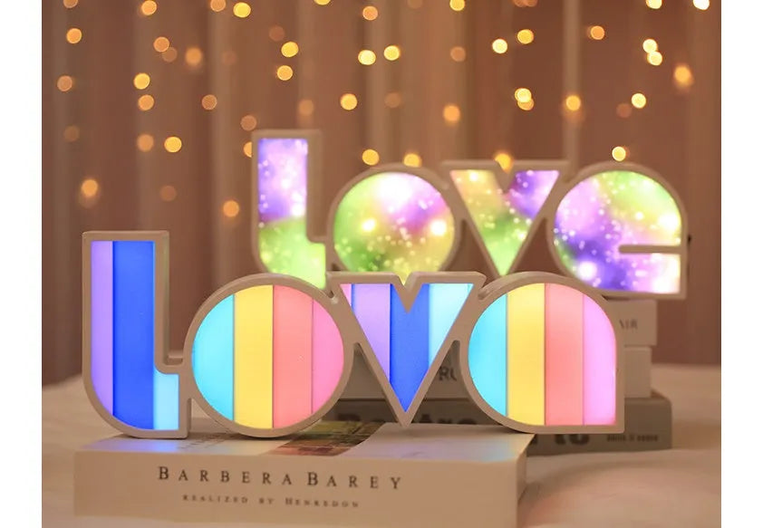 Rainbow style LED Love light for Valentines Day and wedding decoration on a table.