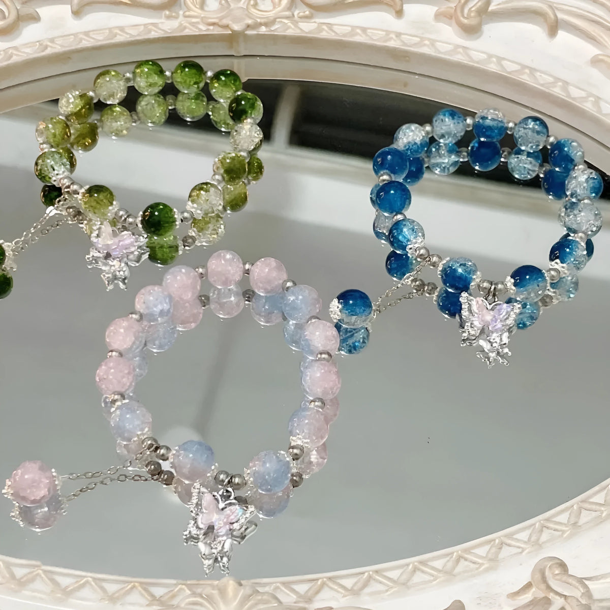 Handmade glass bead bracelet with fairy butterfly broken beads design on white background