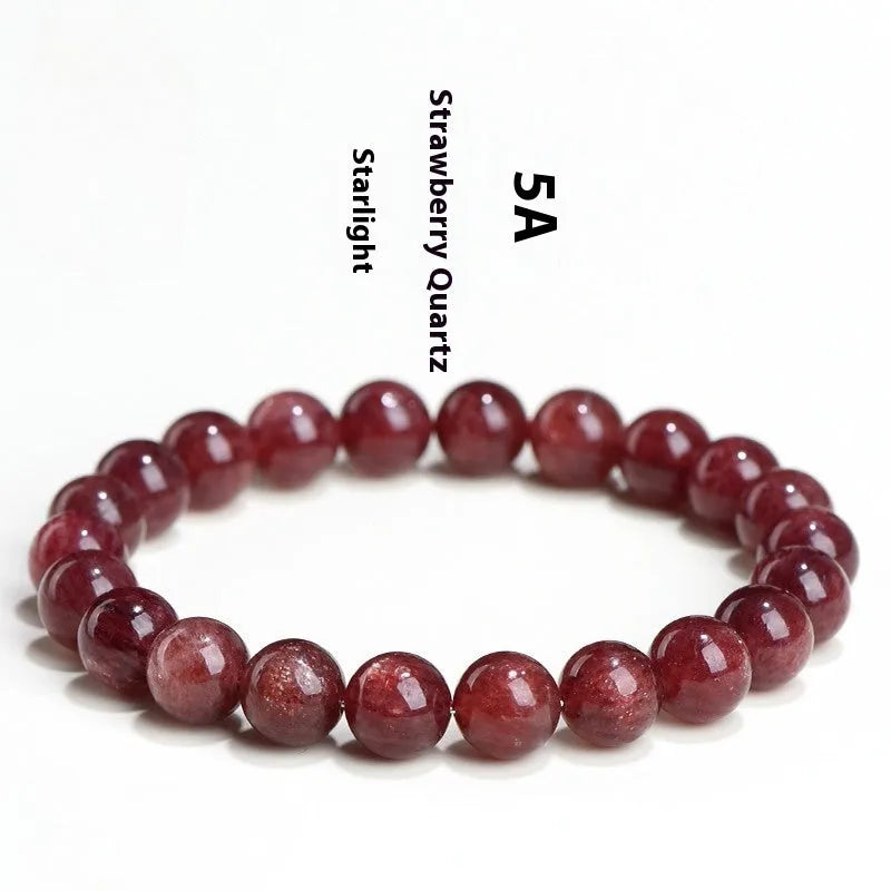 Natural cherry red strawberry quartz bracelet with geometric beads on a wrist.