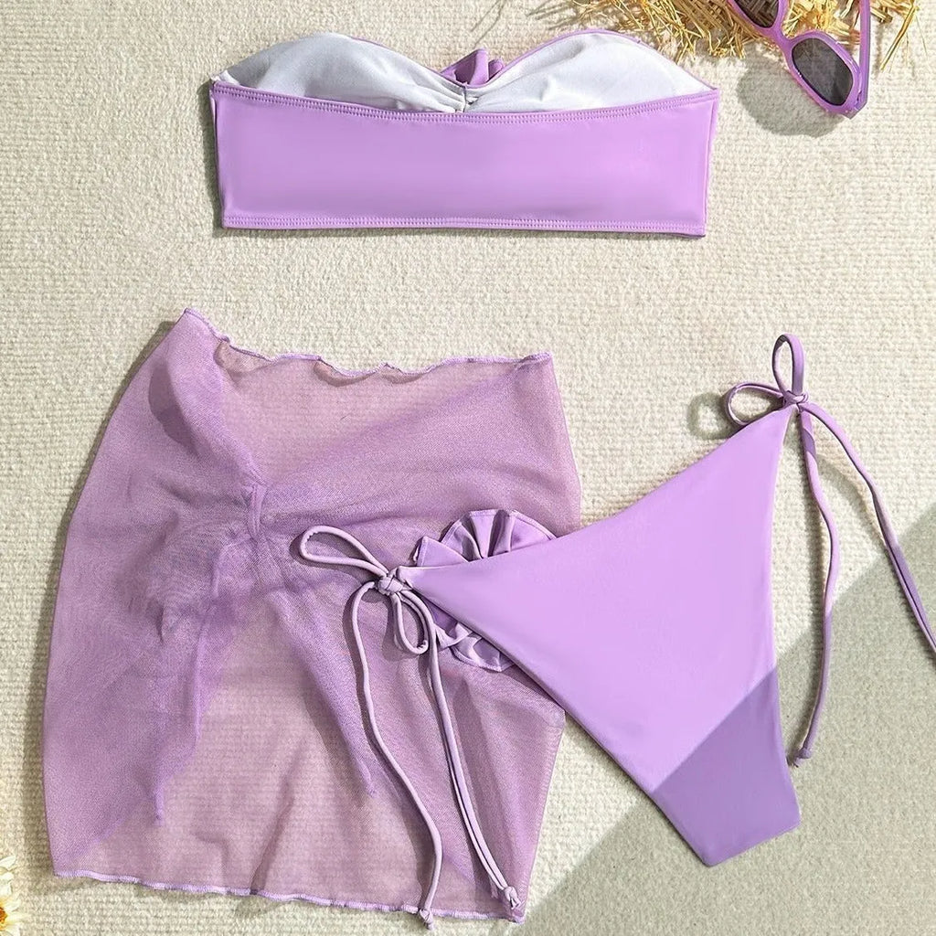 Women's pink floral tube top swimsuit set with matching skirt and pants.