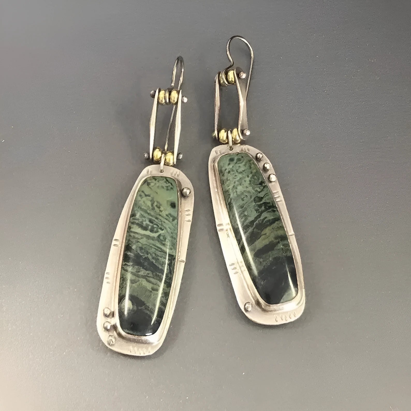A pair of women's geometric-shaped alloy earrings with a two-tone marble pattern finish.