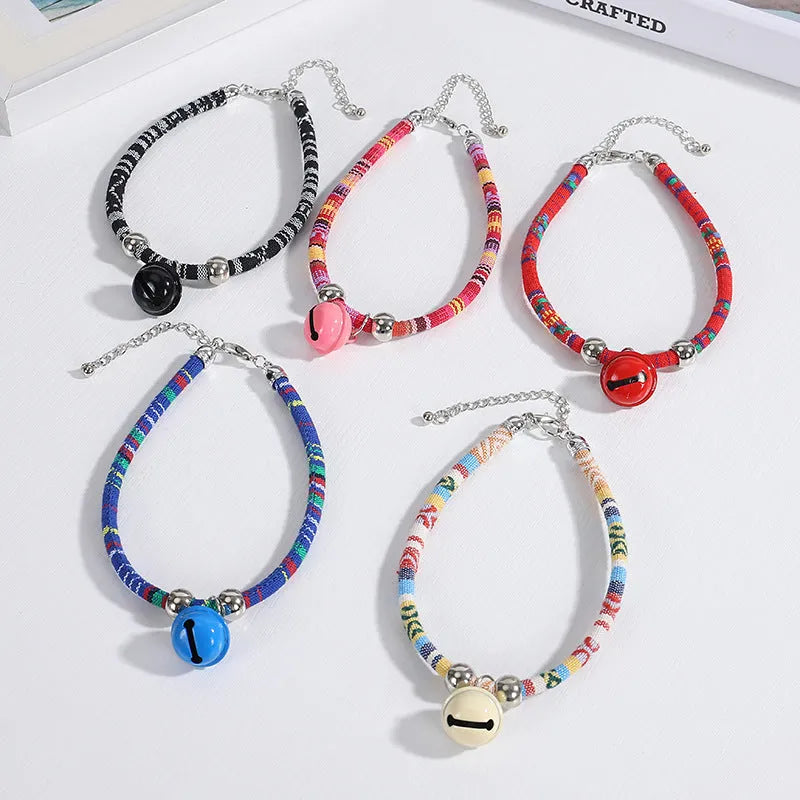 Coloured adjustable pet collar with a metal bell and buckle in ethnic style for dogs and cats.