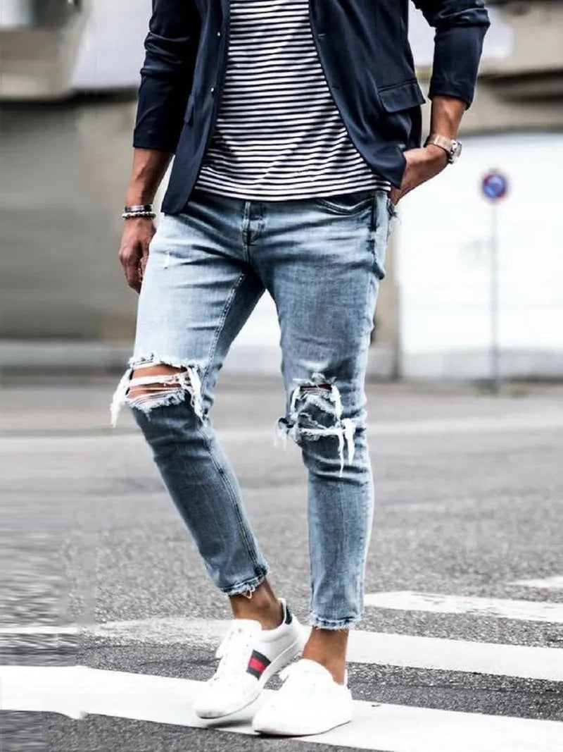 Men's light blue straight fit distressed jeans with embroidered details and zip fly