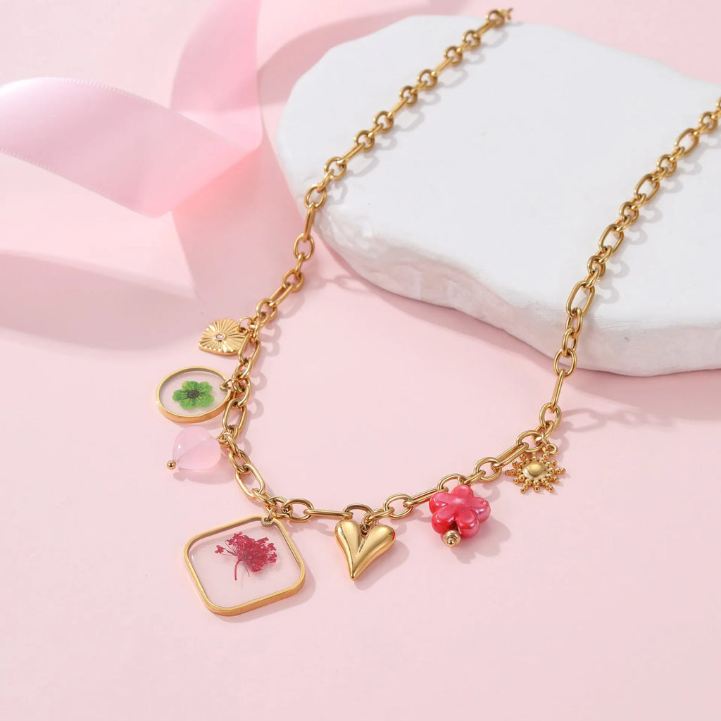 Stainless steel necklace with geometric epoxy flower pendant and 18K gold electroplated finish on a regular chain