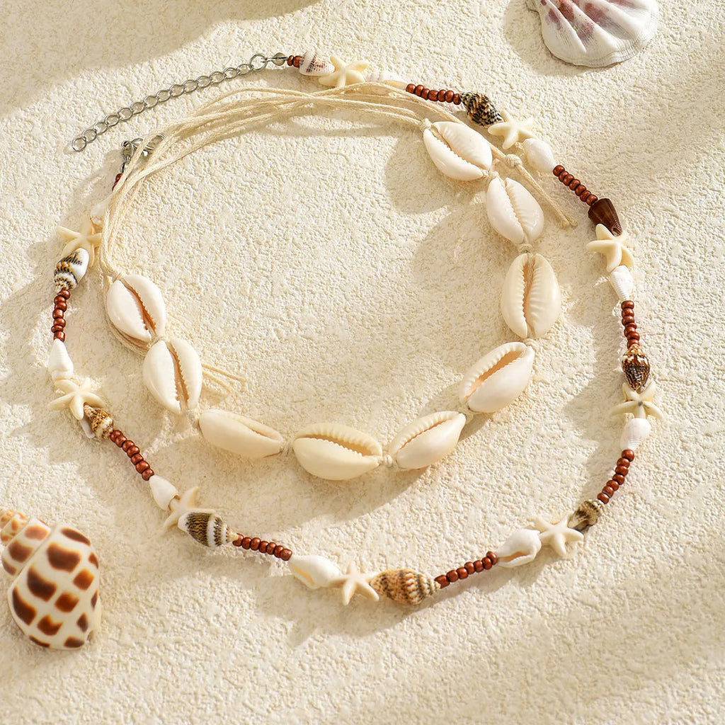 Women's bohemian shell necklace with geometric pendant on regular chain in colour X1900