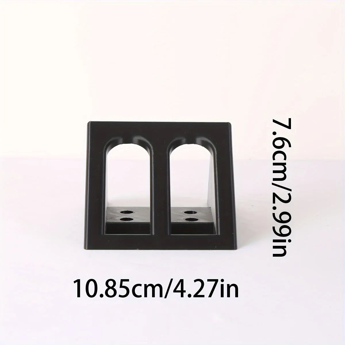 Black plastic punk-style pistol stand for displaying replica firearms.