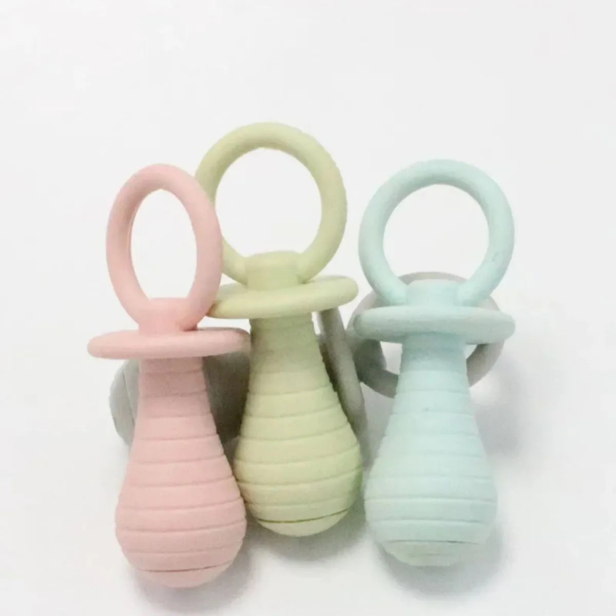 Set of four coloured TPR rubber pacifier chew toys for puppies and kittens on a white background.
