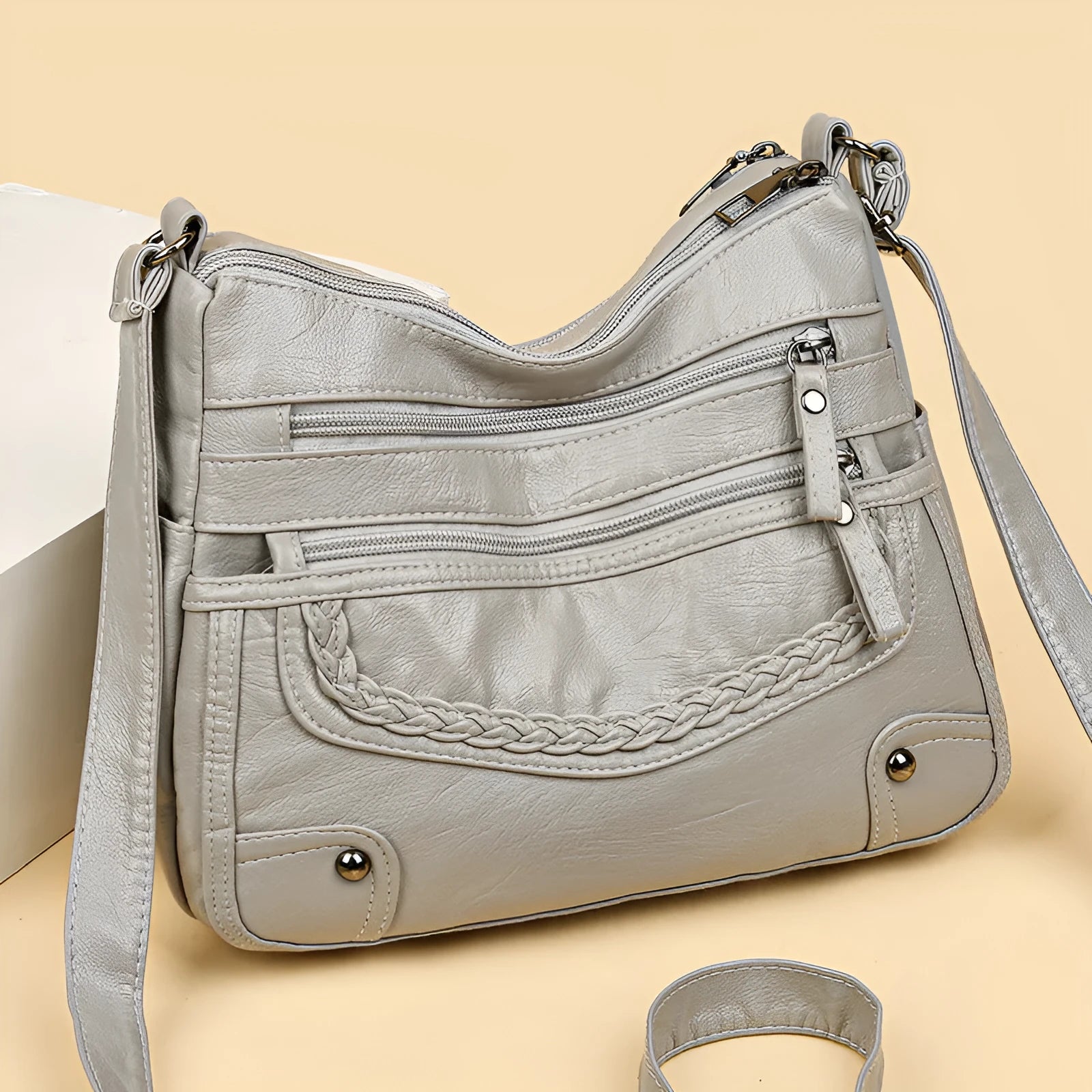 Soft PU messenger bag in horizontal square shape with multiple pockets and sewing thread detailing