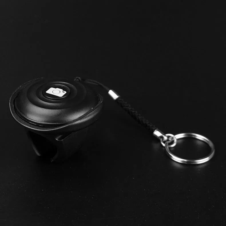 Black Snap Bluetooth remote control for wireless smartphone camera photos on a 10-metre range.