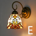 A coloured stained glass wall lamp designed for mounting in a corridor or hallway.