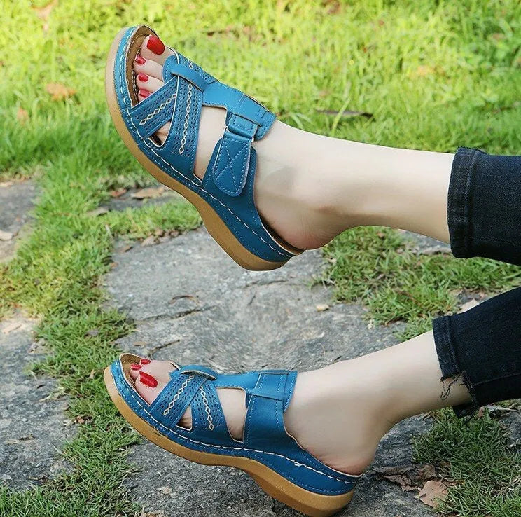 Women's black wedge sandals with a peep toe and Velcro fastening strap.
