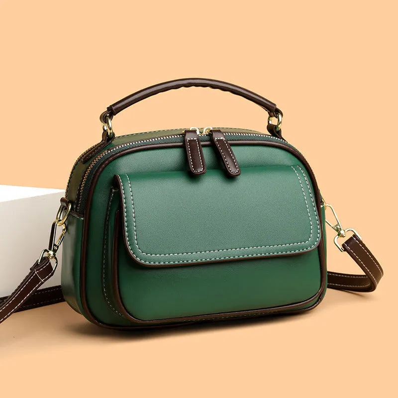 Women's black PU leather cross-body shoulder bag showing horizontal square shape and double straps
