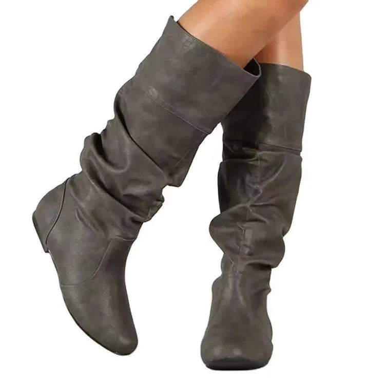 Women's black slip-on flat ankle boots with a round toe and high cylinder shaft.