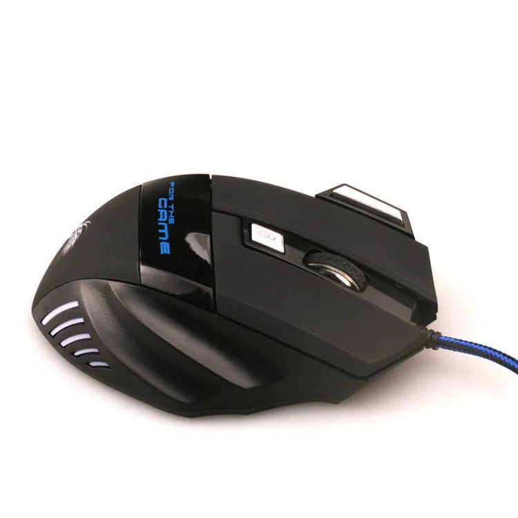 Black wired USB gaming mouse with Tyrannosaurus Rex design, six buttons, and colourful LED light on a desk