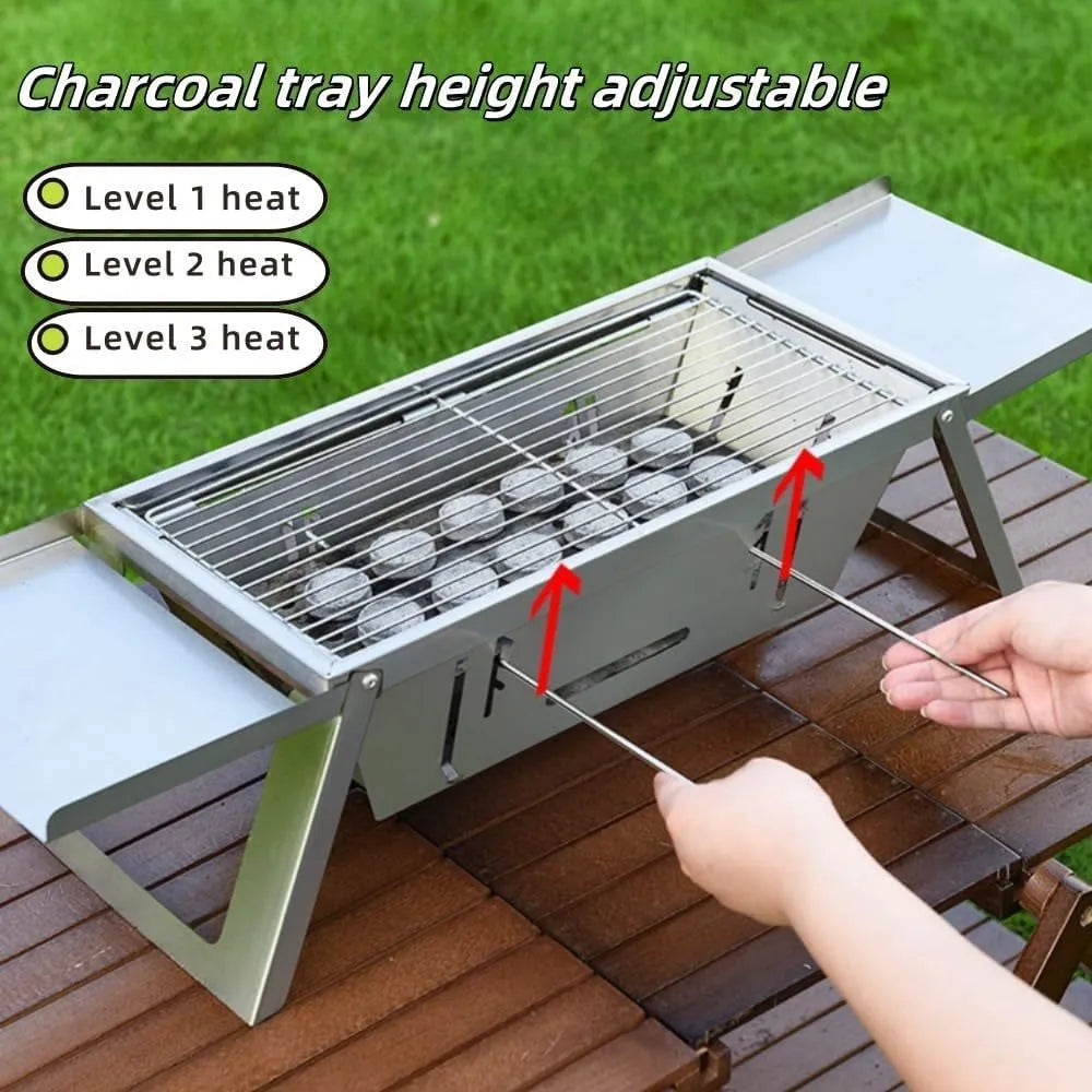 Small foldable portable steel charcoal grill for outdoor use.