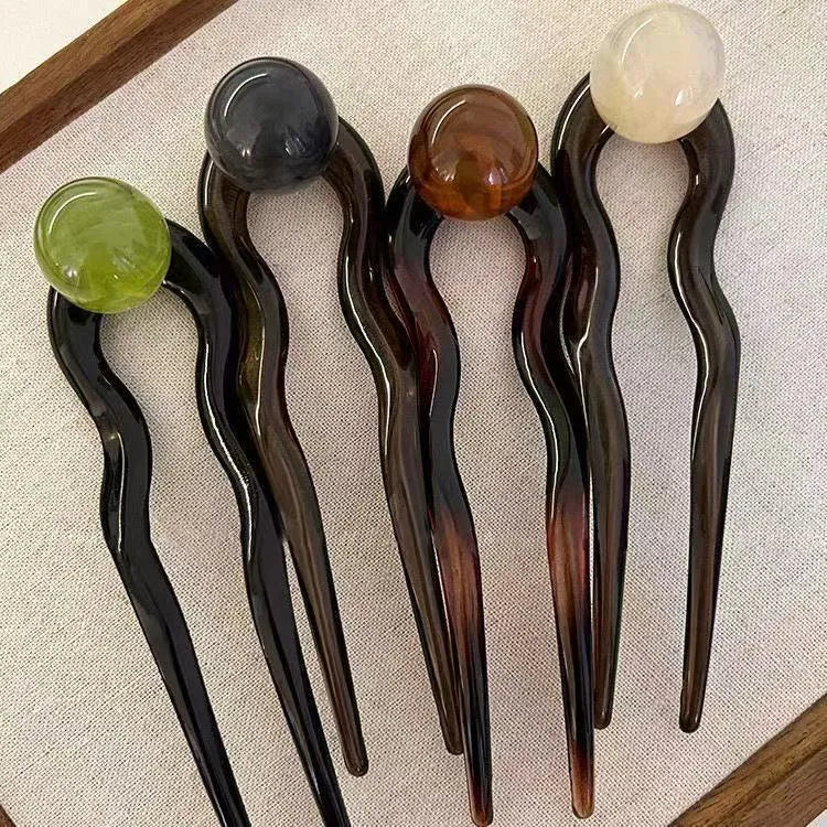 U-shaped hair barrettes with ball decoration in beige, caramel, dark gray and green colour options