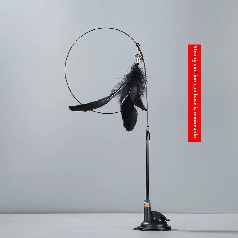 Plastic cat teaser toy with suction cup mount and dangling feather attachment