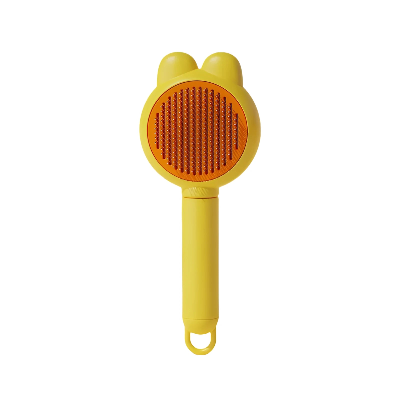 Self-cleaning pet brush with green handle and stainless steel teeth, showing release button mechanism