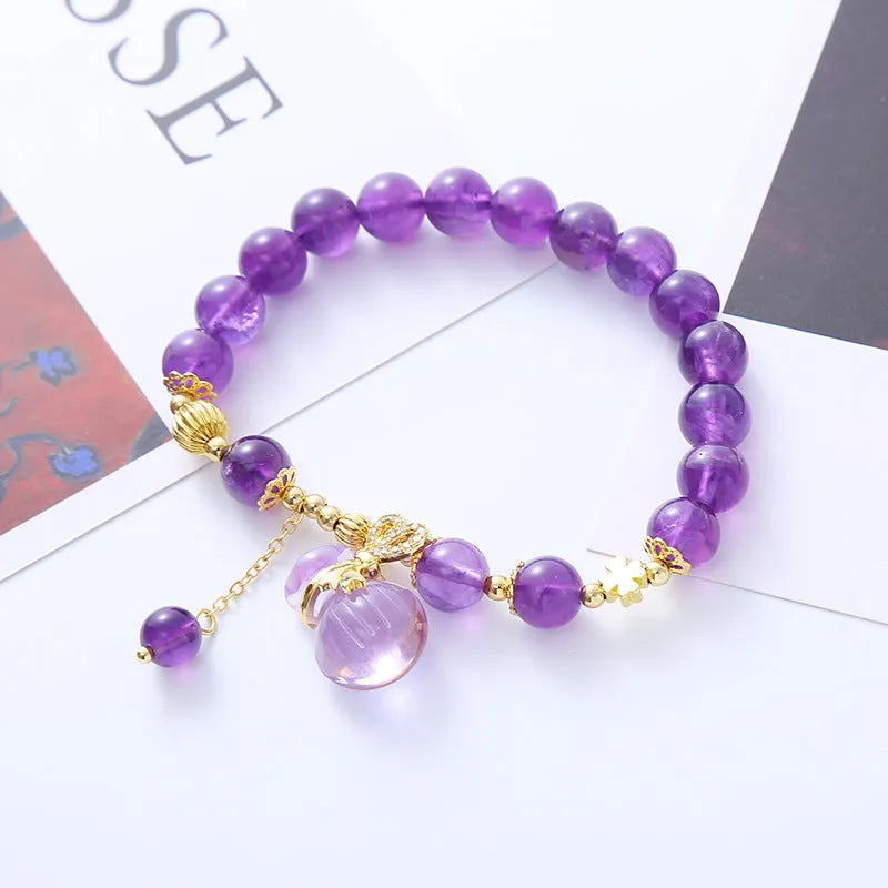 Purple amethyst bracelet with money bag pendant and peace buckle on wrist