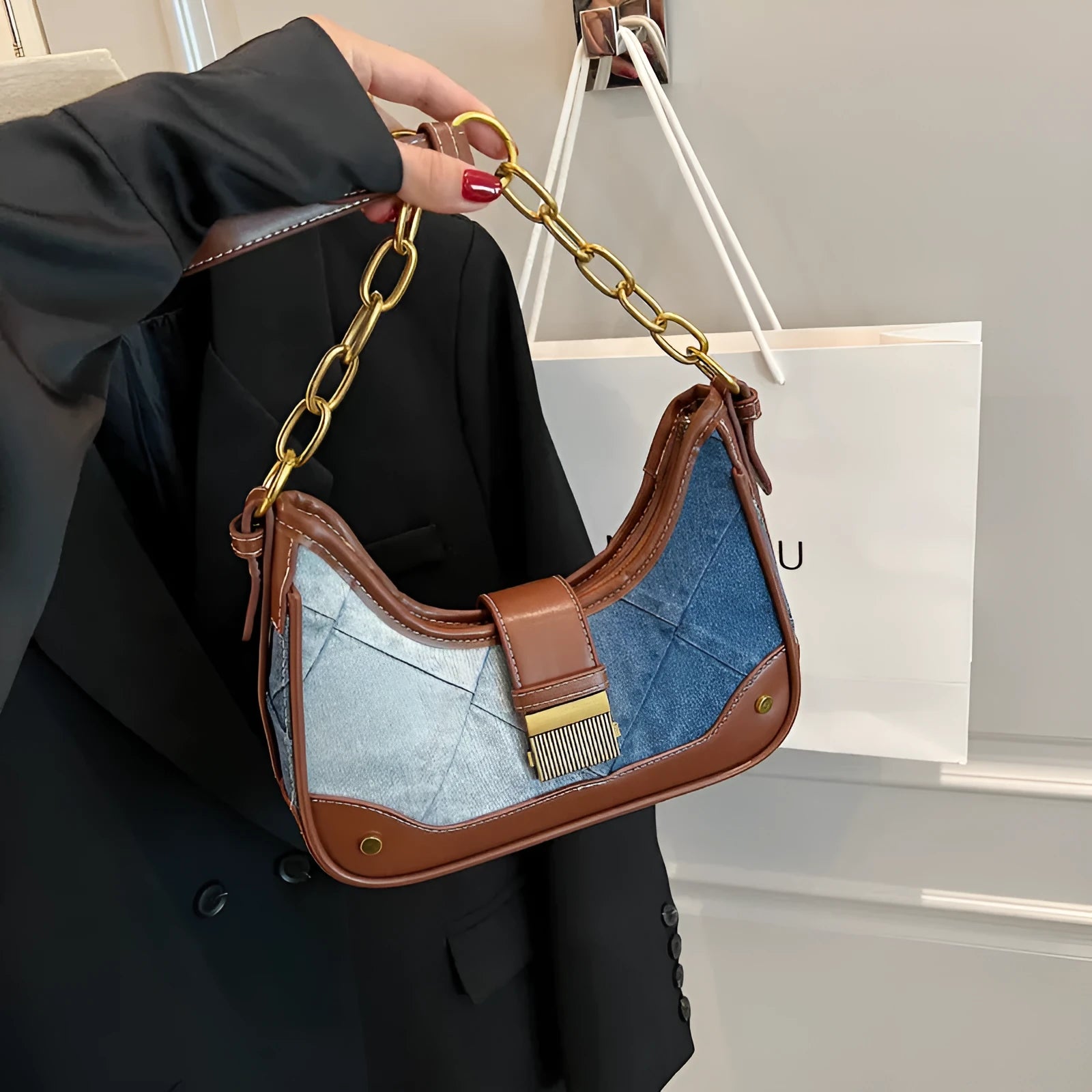 Brown denim women's bucket shoulder bag with diamond mesh detail and chain strap connector.