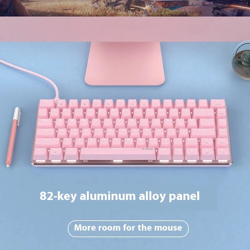 Compact white-backlit mechanical keyboard with 82 keys and metal body next to a laptop.