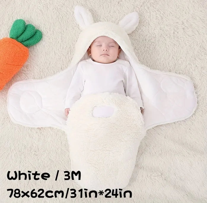 A baby wearing a soft grey fleece sleeping bag with hook-and-loop shoulder straps.
