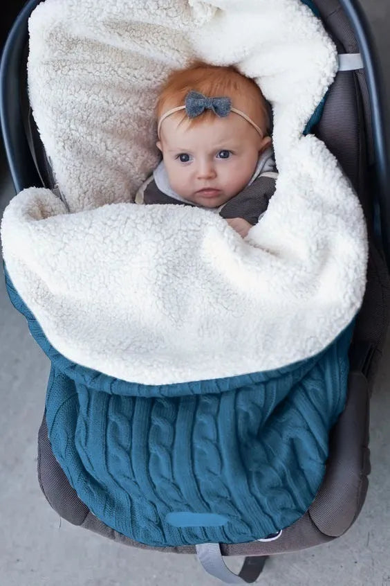 Envelope-style baby stroller sleeping bag in a plain colour, shown on a pram with lamb cashmere lining visible.