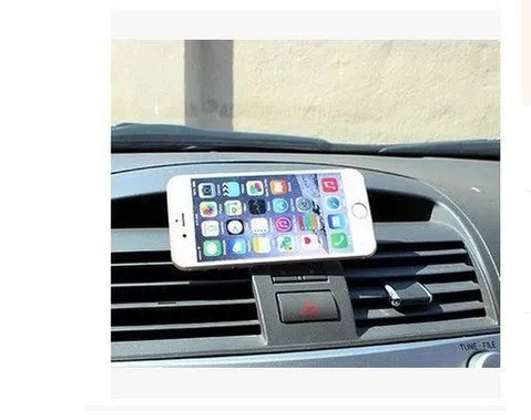 Black magnetic car phone mount on dashboard holding a smartphone with strong magnet support