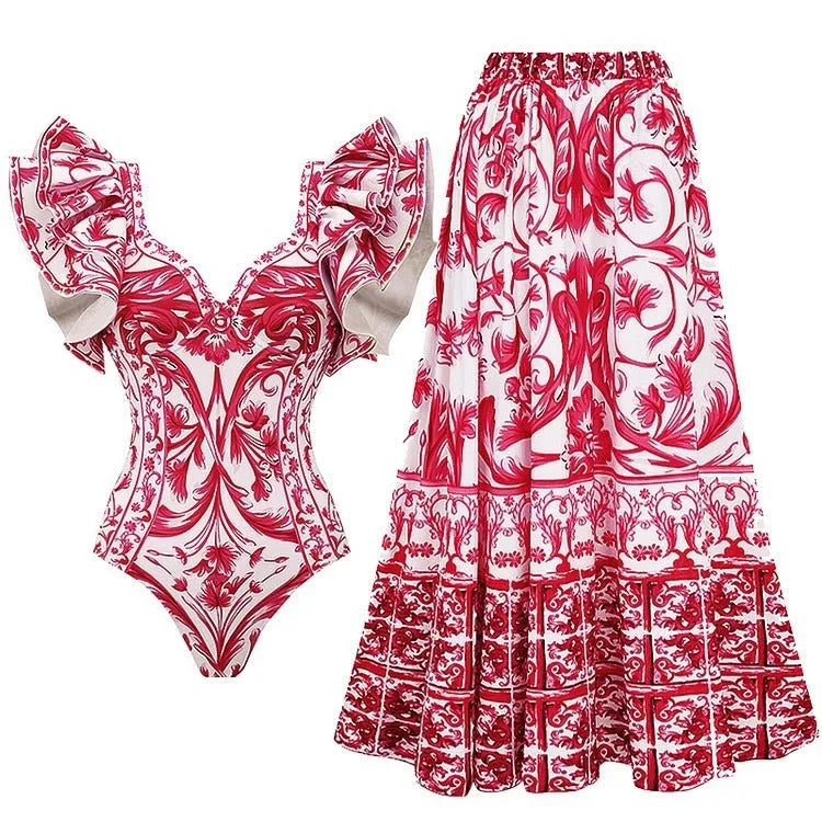 Women's printed one-piece swimsuit on a hanger showing rose pink, white, and blue colour variations.