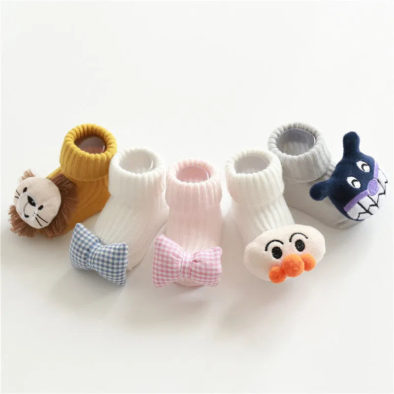 Cotton baby socks with non-slip soles in multiple designs including bows, stars, and animal prints.