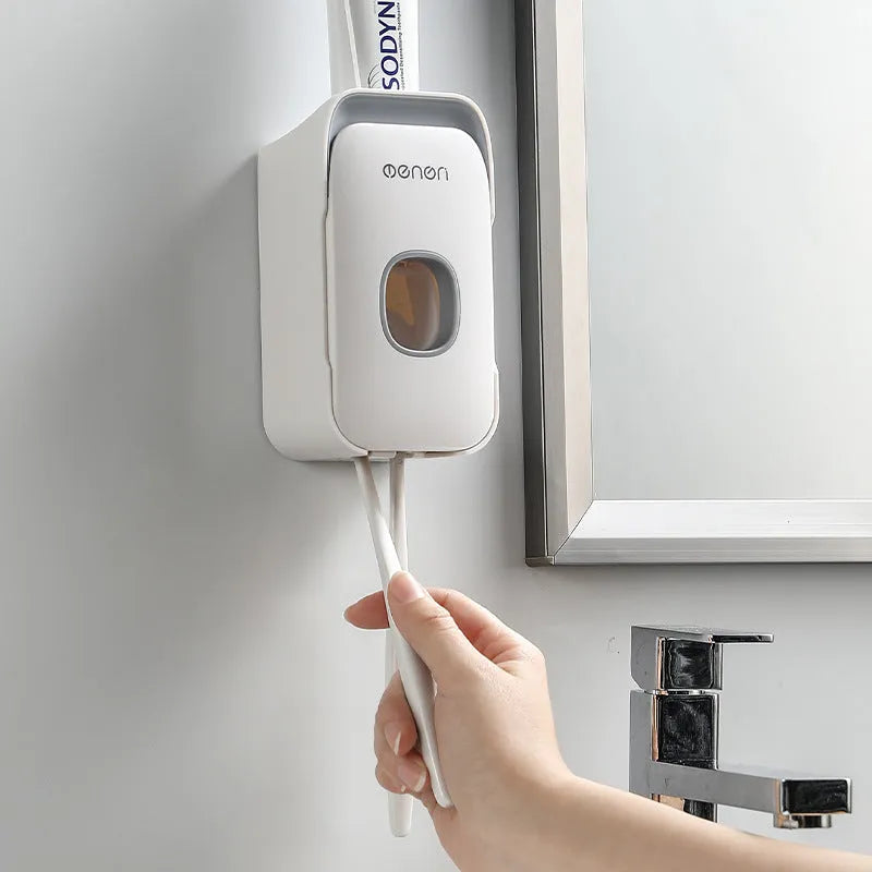 Automatic toothpaste dispenser mounted on bathroom wall in blue colour with touchless sensor