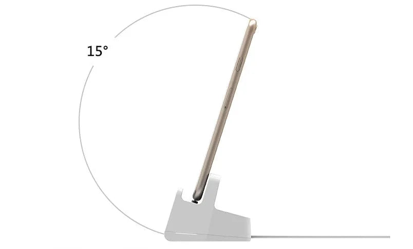 White headphone charging base station on a desk, holding a pair of over-ear headphones.