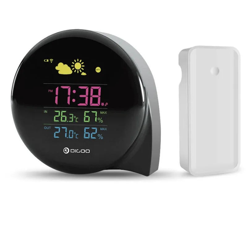 Black wireless weather forecast clock with outdoor sensor showing temperature and humidity on colour LED display