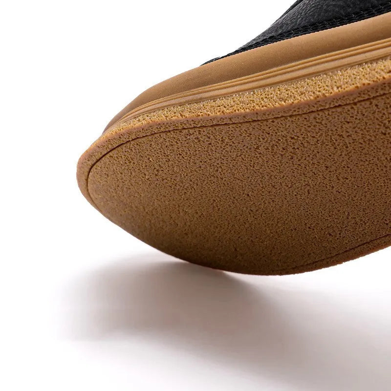 Men's black leather casual shoes with round toe, flat heel, and laced closure on soft rubber sole