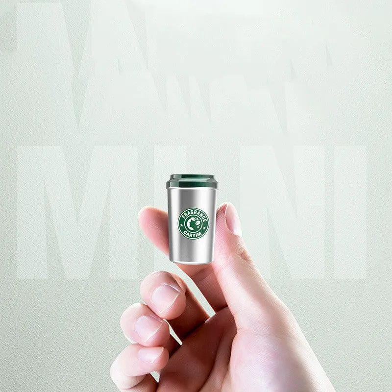 Silver alloy solid perfume seat in coffee cup shape with natural plant fragrance on a wooden desk