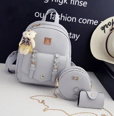 Women's three-piece PU leather bag set showing backpack, shoulder bag and card holder in matching colour.