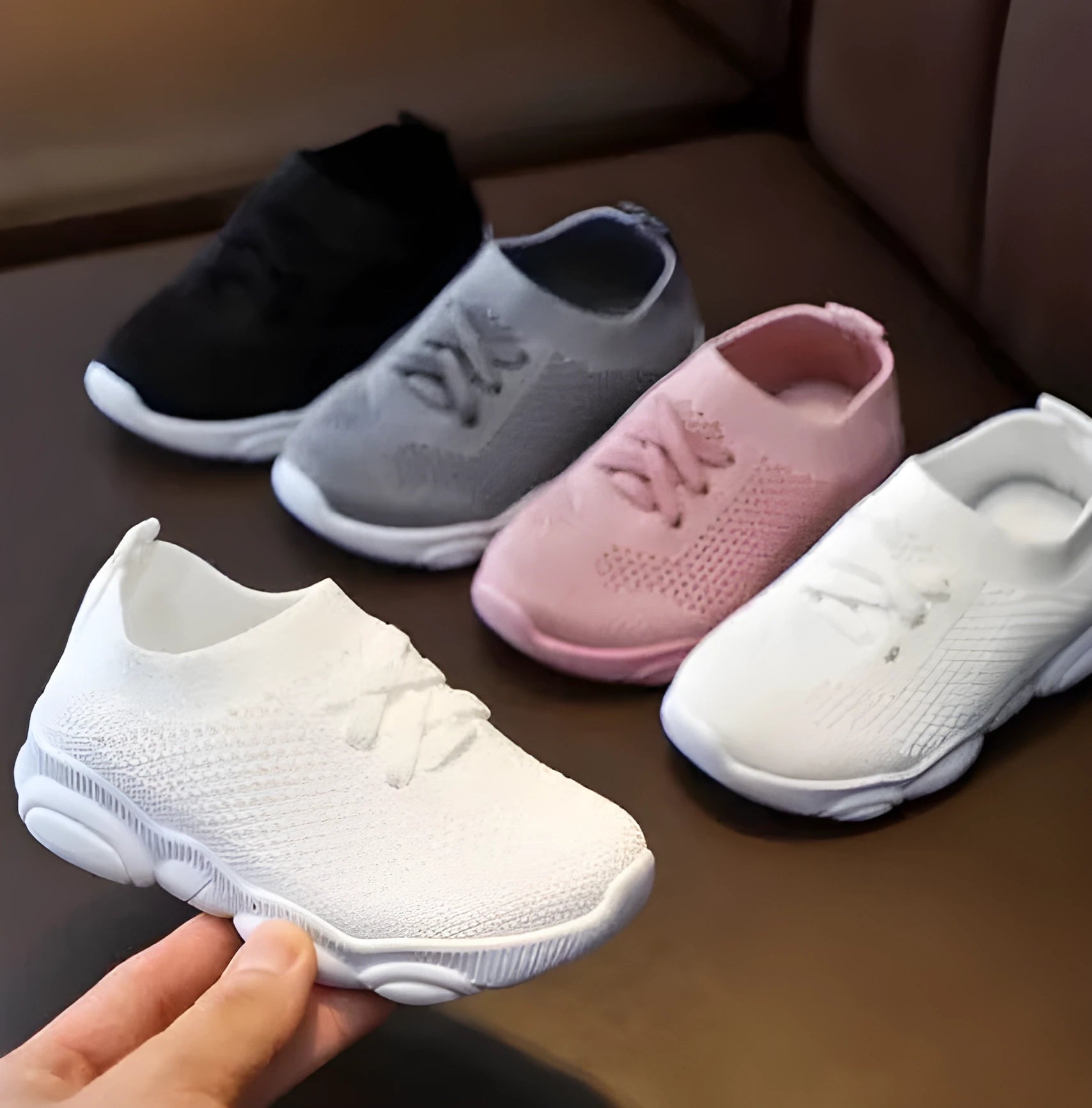 Children's white lazy slip-on shoe with fabric upper and textured non-slip rubber sole.