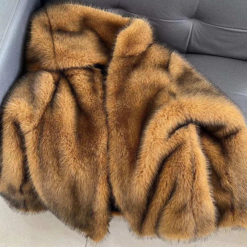 A silver grey loose-fitting mid-length artificial fur coat for women on a hanger.