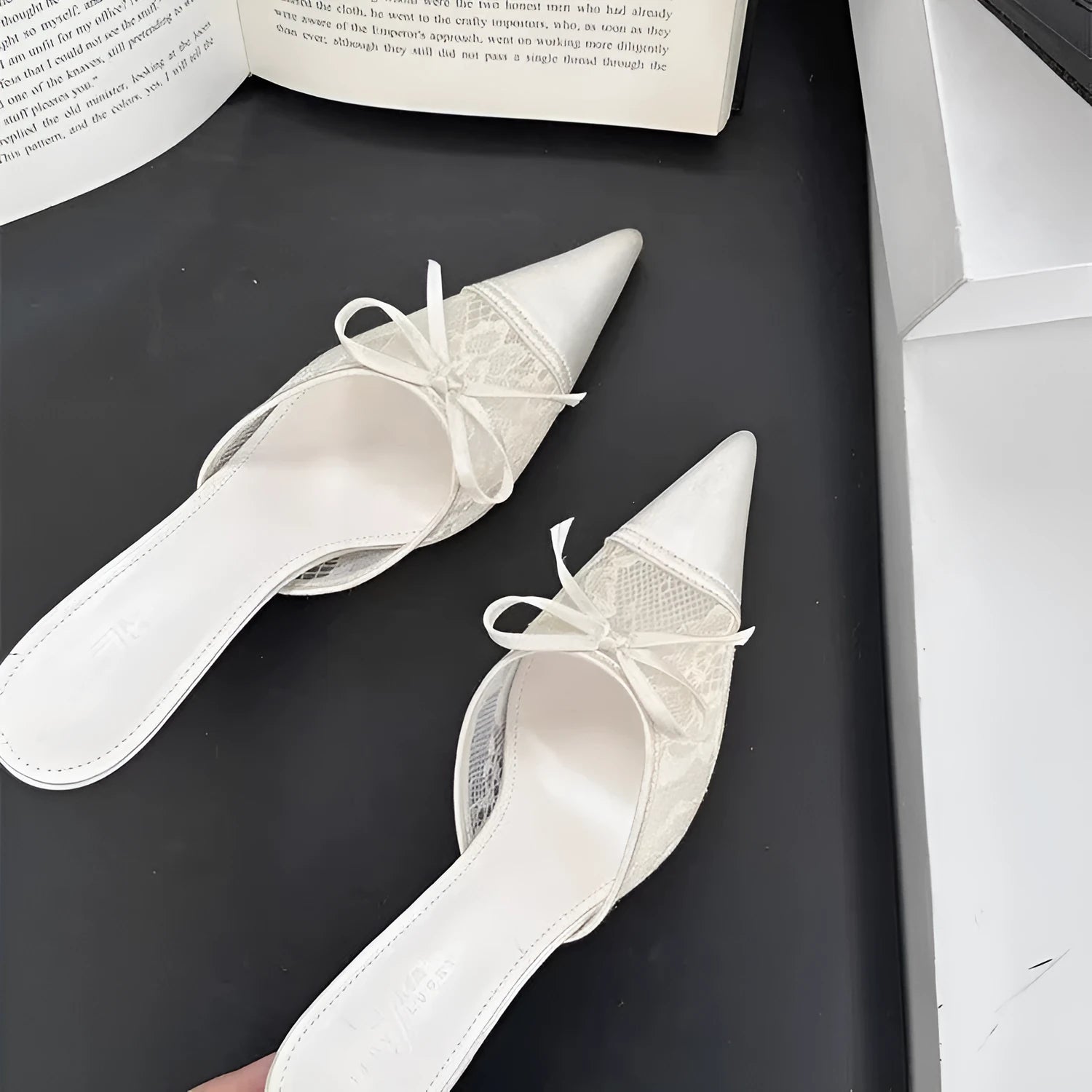 Women's lace-inspired pointed toe high heels with a bowknot detail on the mesh upper.