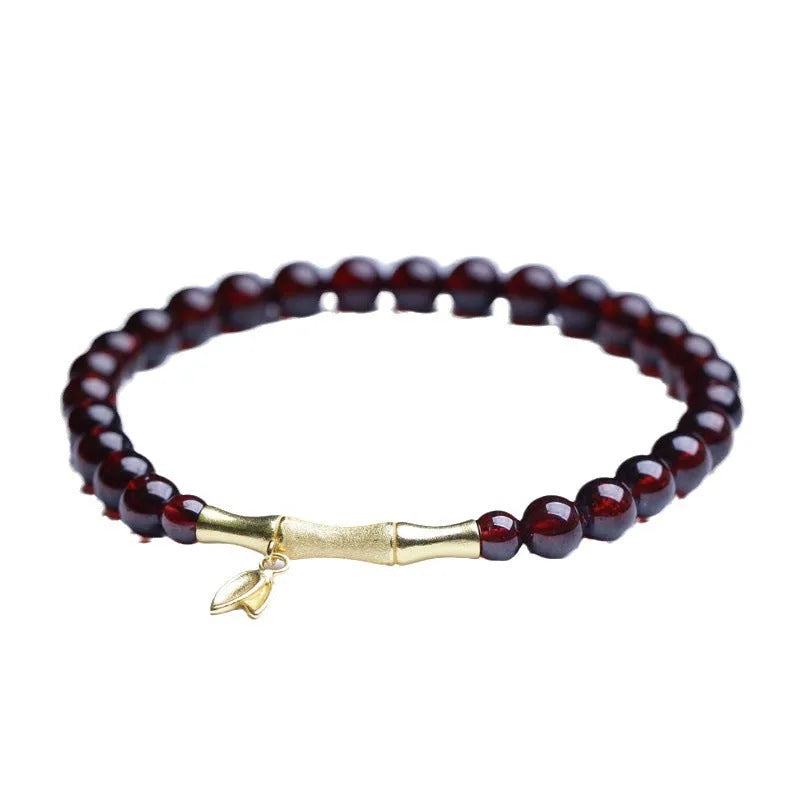 Natural garnet stone set in a 6mm bamboo joint ring bracelet with copper or silver finish.