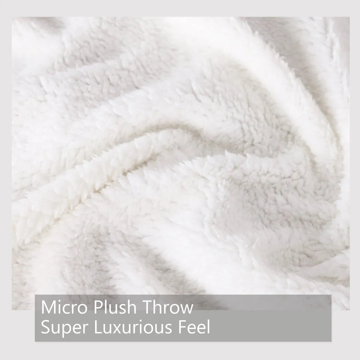 Dinosaur themed white sherpa fleece lamb wool blanket folded on a sofa