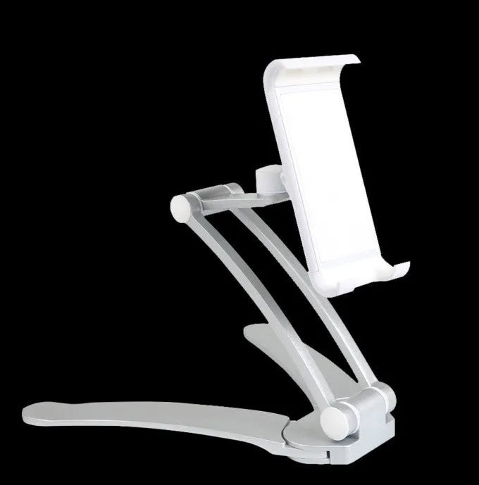 Silver aluminium alloy desktop stand holding a tablet at an angle, with adjustable clips and a white mounting base.