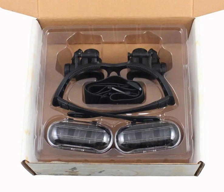 Black double eye magnifier glasses with LED lights and multiple lenses for hands-free watch and electronic repair.