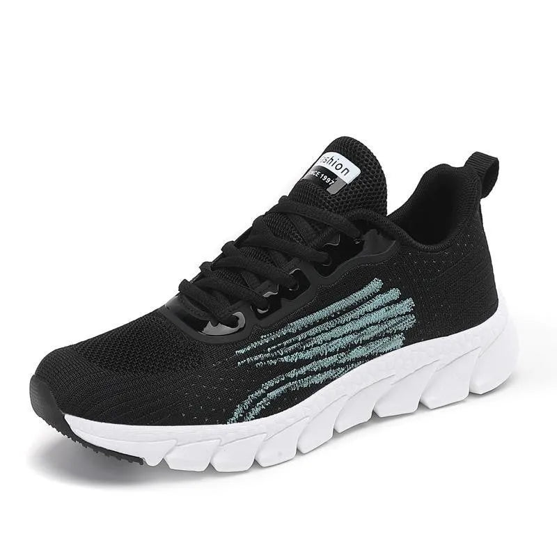 Women's low-top platform sneakers in black and white with cross-strap detail and MD sole.