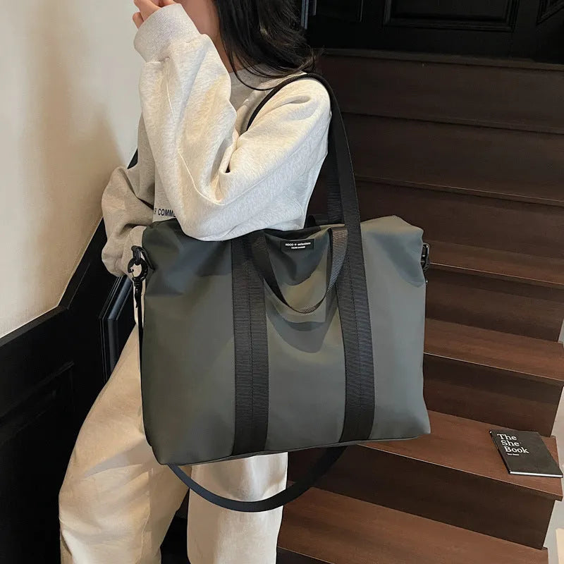 Lightweight Oxford cloth tote bag in black, grey, or champagne with 20-35L capacity for travel