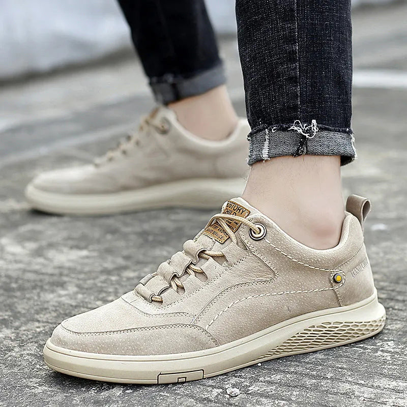 Men's brown leather sports shoes with suede finish and anti-skid plastic sole on concrete background