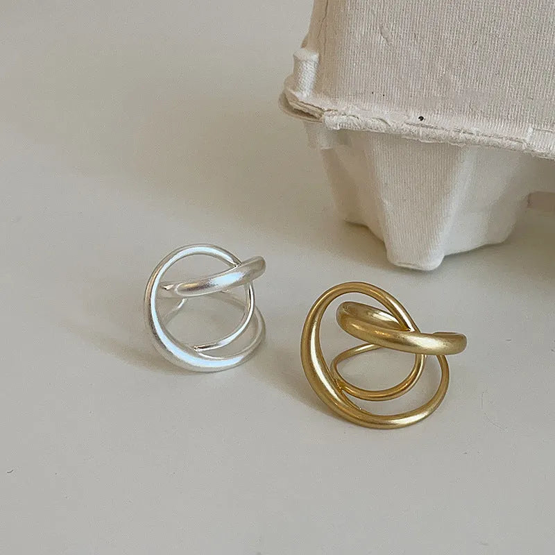 Geometric open ring with three-dimensional interlaced design in matte metal finish