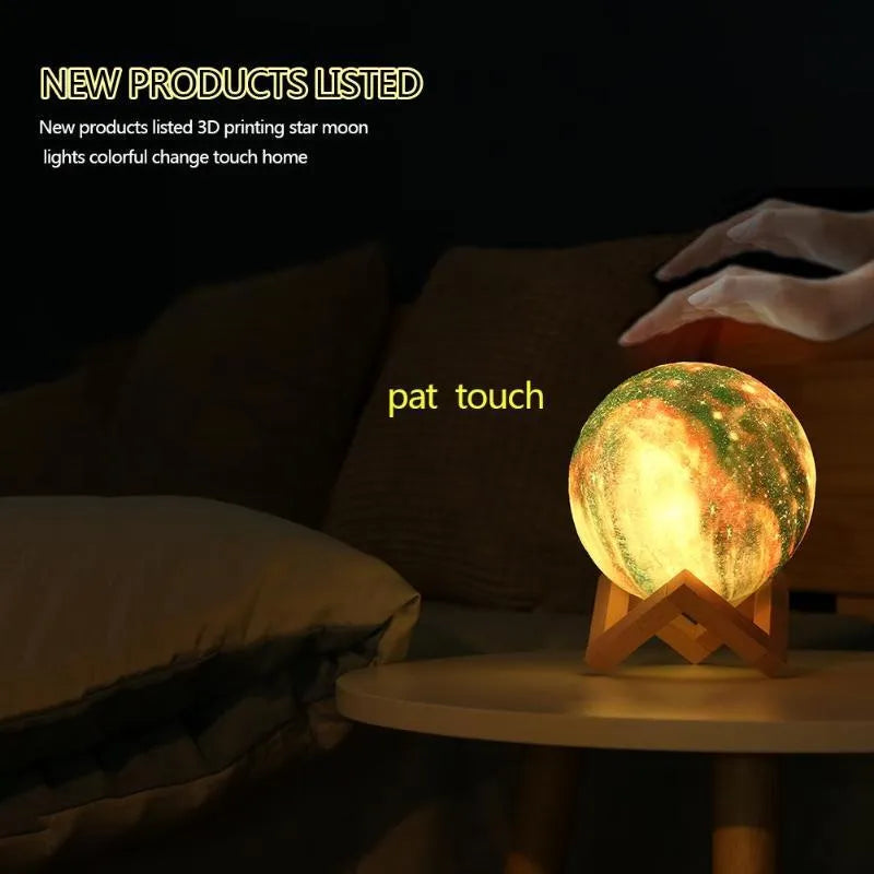 3D-printed white lunar sphere night light with crater texture on a dark surface.